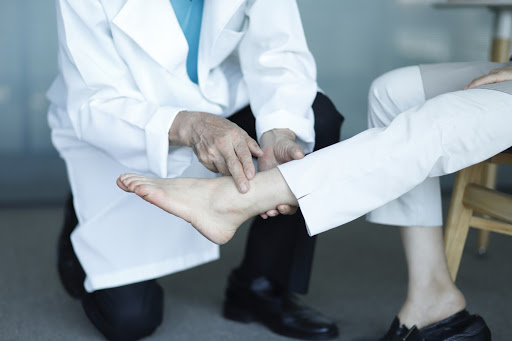 Doctor analyzing foot of patient
